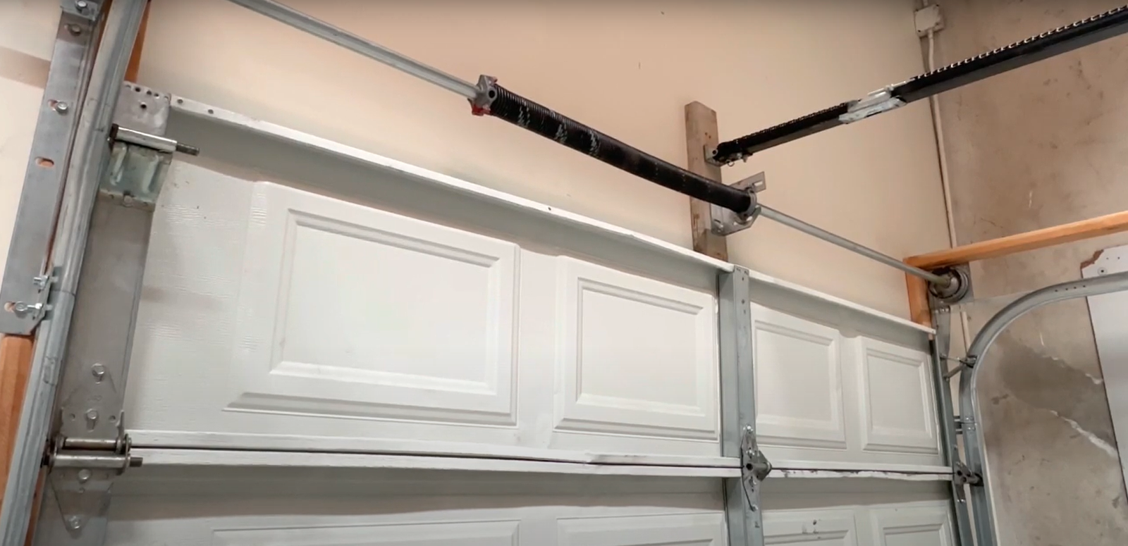 Garage door professional repairing torsion spring for a smooth and safe operation - Boca Raton Garage Door Repair