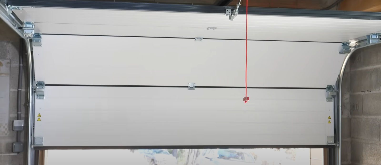 A side-by-side comparison of a damaged garage door being repaired and a new door being professionally installed by Boca Raton Garage Door Repair experts."