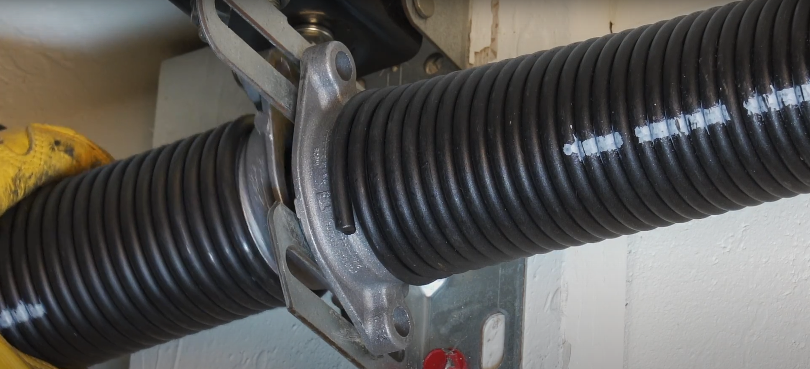 Garage door professional repairing torsion spring for a smooth and safe operation - Boca Raton Garage Door Repair