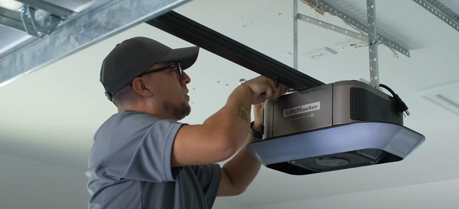 A professional technician from Boca Raton Garage Door Repair inspecting a garage door opener to address functional issues and restore safety