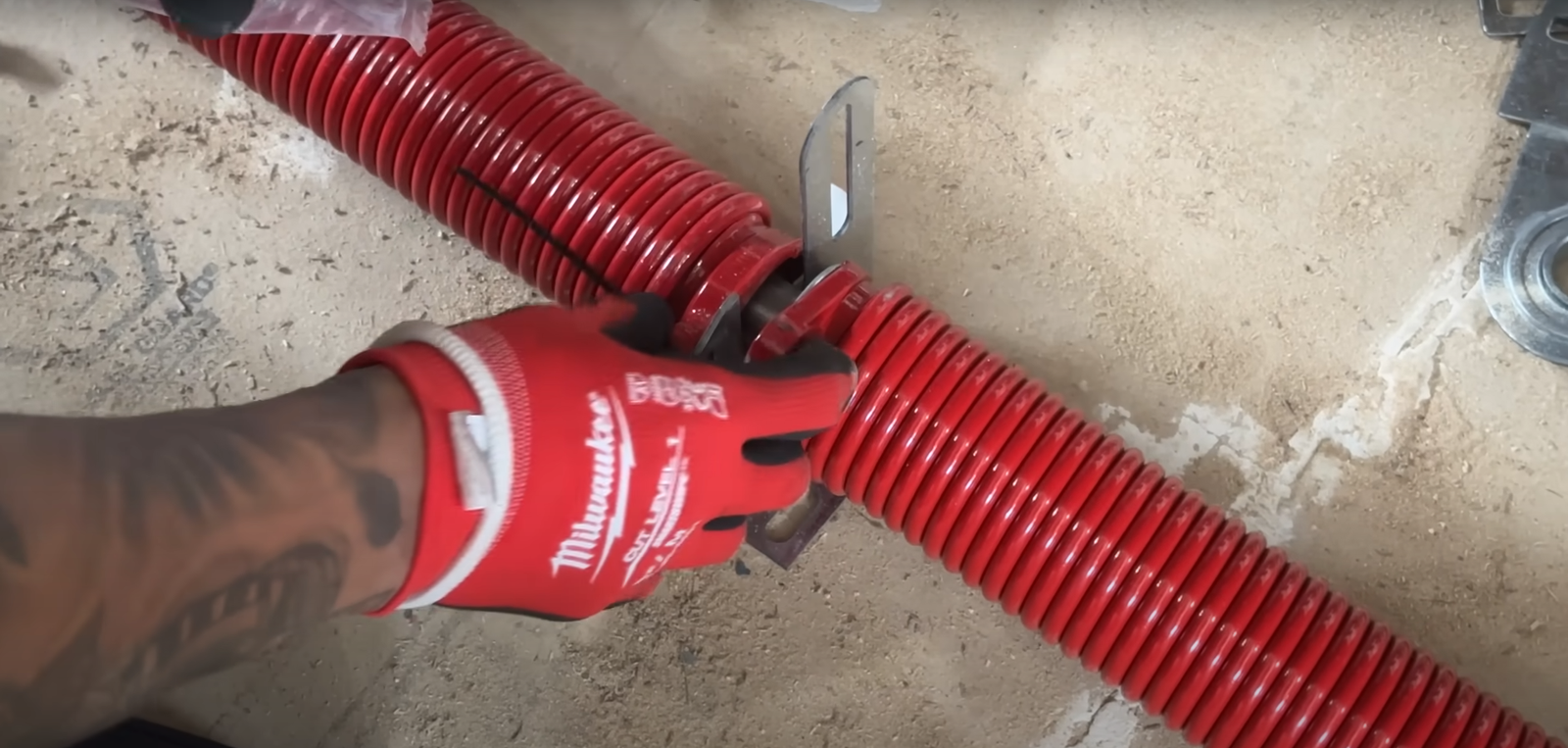 Garage door technician inspecting springs for potential issues - Boca Raton Garage Door Repair